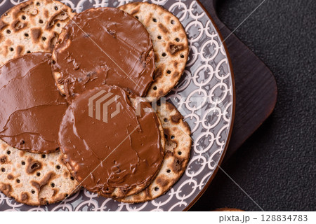 Matzah with chocolate paste for the Jewish holiday of passover Matzah with chocolate paste for the Jewish holiday of passover 128834783