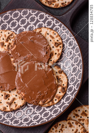Matzah with chocolate paste for the Jewish holiday of passover 128834785