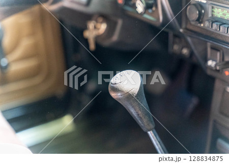 Gear stick showing four speed plus reverse in vintage car interior Gear stick showing four speed plus reverse in vintage car interior 128834875
