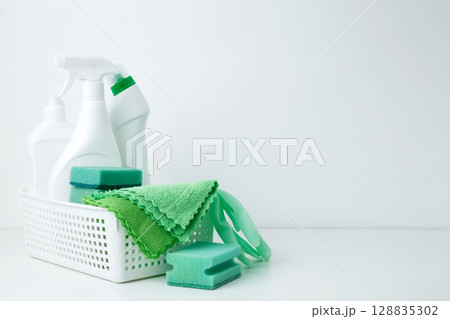 Cleaning supplies in a container, ready for a productive and satisfying spring refresh. Household cleaning and hygiene concept Cleaning supplies in a container, ready for a productive and satisfying spring refresh. Household cleaning and hygiene concept 128835302