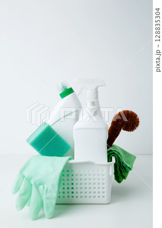 Cleaning supplies in a container, ready for a productive and satisfying spring refresh. Household cleaning and hygiene concept 128835304