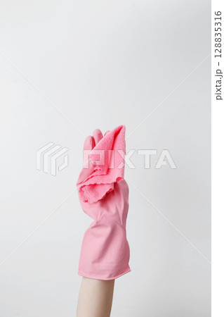 Blue cleaning products, the woman cleans using rubber gloves and a microfiber cloth. Household cleaning and hygiene concept Blue cleaning products, the woman cleans using rubber gloves and a microfiber cloth. Household cleaning and hygiene concept 128835316