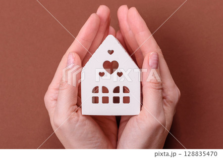 Home, house, buying property for business or life. Concept with human hand Home, house, buying property for business or life. Concept with human hand 128835470
