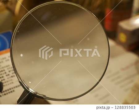 old magnifying glass detail close up 128835503