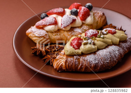 Food for breakfast sweet strawberry croissants with chocolate filling Food for breakfast sweet strawberry croissants with chocolate filling 128835982