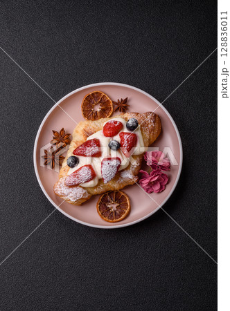 Food for breakfast sweet strawberry croissants with chocolate filling 128836011