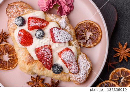 Food for breakfast sweet strawberry croissants with chocolate filling 128836019