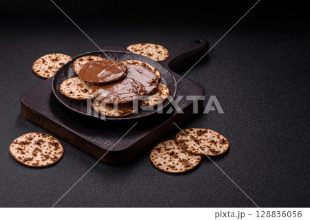 Matzah with chocolate paste for the Jewish holiday of passover Matzah with chocolate paste for the Jewish holiday of passover 128836056