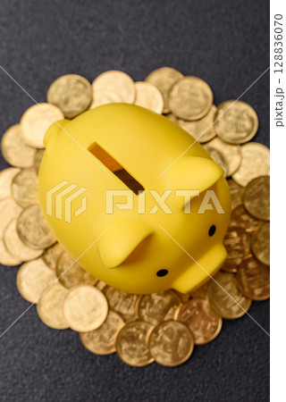 Piggy bank as a financial conceptual background with coins, doing business, saving money 128836070