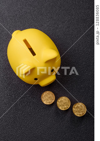 Piggy bank as a financial conceptual background with coins, doing business, saving money Piggy bank as a financial conceptual background with coins, doing business, saving money 128836085