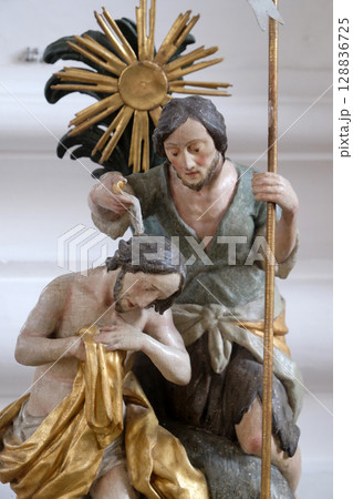 Baptism of the Lord, baptismal font in the Saint Martin church in Unteressendorf, Germany Baptism of the Lord, baptismal font in the Saint Martin church in Unteressendorf, Germany 128836725