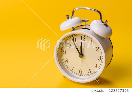Vintage alarm clock as a conceptual background for deadlines for tasks in business Vintage alarm clock as a conceptual background for deadlines for tasks in business 128837398