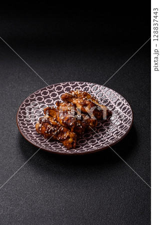 Grilled chicken wings in teriyaki sauce. Hot spicy takeaway food 128837443
