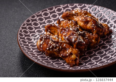 Grilled chicken wings in teriyaki sauce. Hot spicy takeaway food 128837444