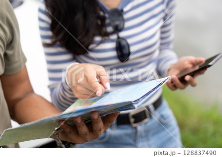 Couple planning their next adventure with a map Couple planning their next adventure with a map 128837490