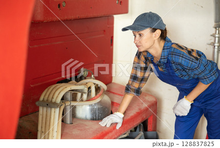 Adult woman near automatic milking machine Adult woman near automatic milking machine 128837825