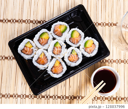 Tasty sushi california roll with salmon and avocado 128837996