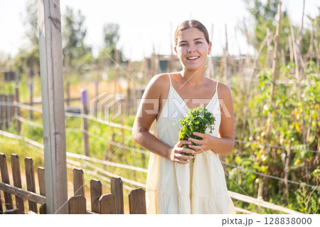 Young woman posing in cottage garden Young woman posing in cottage garden 128838000