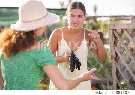 Adult and young woman quarreling in garden 128838070