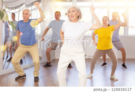 Elderly woman dances modern dances in group Elderly woman dances modern dances in group 128838117