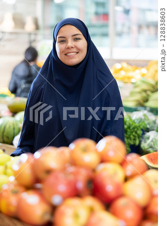 Portrait of a positive contented woman in a veil in supermarket 128838603
