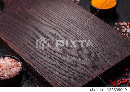 Wooden cutting board blank as a backdrop for cooking in the kitchen 128839040