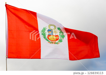 Flag of Peru waving on cloudy sky during daytime Flag of Peru waving on cloudy sky during daytime 128839113