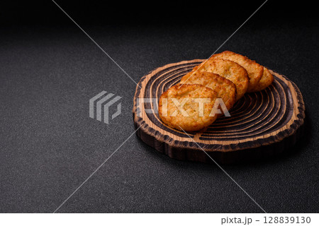 Potato hash browns, a meal with onions, cabbage in the form of fritters 128839130