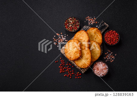 Potato hash browns, a meal with onions, cabbage in the form of fritters 128839163