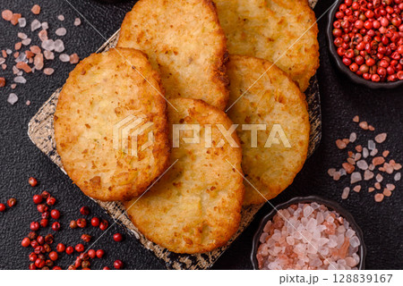 Potato hash browns, a meal with onions, cabbage in the form of fritters 128839167
