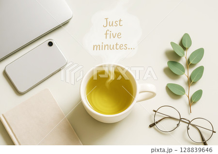 Tea Break Scene With Steam Saying Just Five Minutes On Minimal Desk. Concept For Mindful Pauses, Digital Detox, Work-Life Balance, Wellness Rituals, And Calm Productivity Visual Aesthetic 128839646