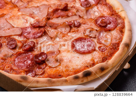 Italian pepperoni pizza with cheese and salami, tomatoes and sauce Italian pepperoni pizza with cheese and salami, tomatoes and sauce 128839664