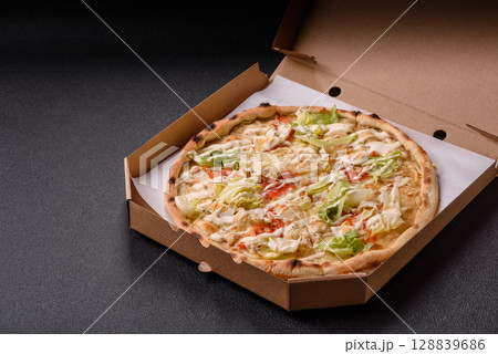 Italian caesar pizza with cheese and chicken, lettuce leaves and sauce Italian caesar pizza with cheese and chicken, lettuce leaves and sauce 128839686