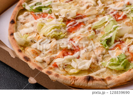 Italian caesar pizza with cheese and chicken, lettuce leaves and sauce Italian caesar pizza with cheese and chicken, lettuce leaves and sauce 128839690