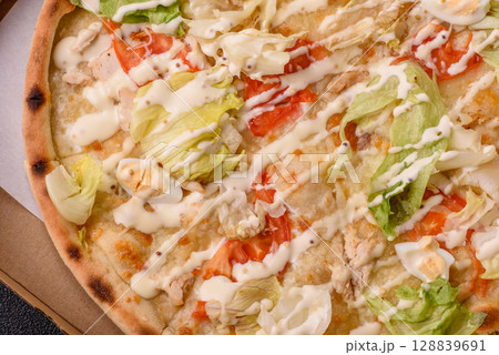 Italian caesar pizza with cheese and chicken, lettuce leaves and sauce Italian caesar pizza with cheese and chicken, lettuce leaves and sauce 128839691