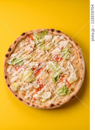 Italian caesar pizza with cheese and chicken, lettuce leaves and sauce 128839704