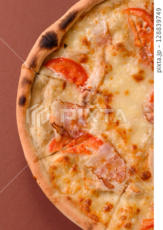 Italian pizza with chicken and bacon, cheese, tomatoes and sauce Italian pizza with chicken and bacon, cheese, tomatoes and sauce 128839749