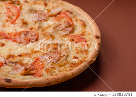 Italian pizza with chicken and bacon, cheese, tomatoes and sauce Italian pizza with chicken and bacon, cheese, tomatoes and sauce 128839751