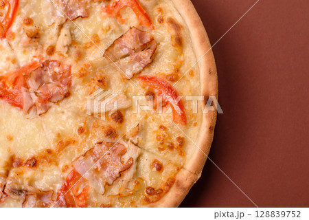 Italian pizza with chicken and bacon, cheese, tomatoes and sauce Italian pizza with chicken and bacon, cheese, tomatoes and sauce 128839752