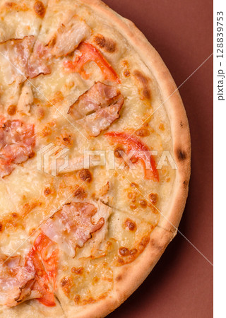 Italian pizza with chicken and bacon, cheese, tomatoes and sauce Italian pizza with chicken and bacon, cheese, tomatoes and sauce 128839753