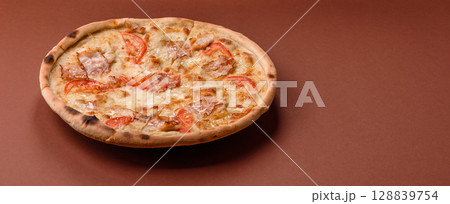 Italian pizza with chicken and bacon, cheese, tomatoes and sauce Italian pizza with chicken and bacon, cheese, tomatoes and sauce 128839754