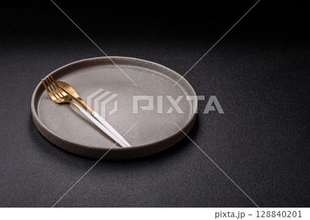 Empty plate with utensils as a conceptual background for lunch, breakfast, meal Empty plate with utensils as a conceptual background for lunch, breakfast, meal 128840201