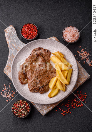 Steak, grilled beef, sirloin cooked on the barbecue with salt and spices 128840417