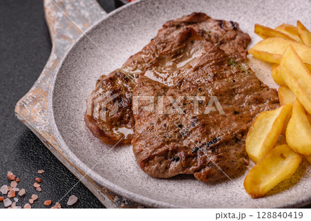 Steak, grilled beef, sirloin cooked on the barbecue with salt and spices Steak, grilled beef, sirloin cooked on the barbecue with salt and spices 128840419