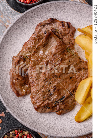 Steak, grilled beef, sirloin cooked on the barbecue with salt and spices 128840421