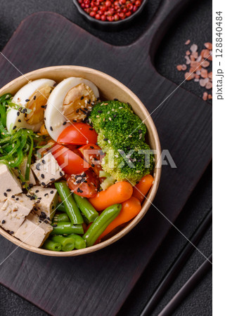 Vegan salad, bowls with chickpeas, broccoli, tomatoes, tofu cheese and boiled eggs Vegan salad, bowls with chickpeas, broccoli, tomatoes, tofu cheese and boiled eggs 128840484