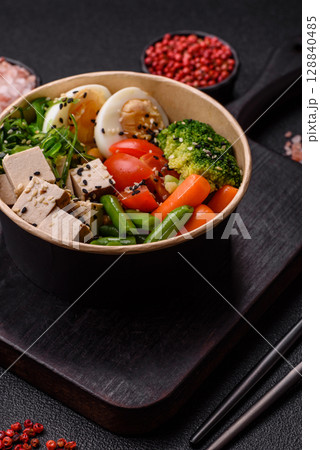 Vegan salad, bowls with chickpeas, broccoli, tomatoes, tofu cheese and boiled eggs Vegan salad, bowls with chickpeas, broccoli, tomatoes, tofu cheese and boiled eggs 128840485