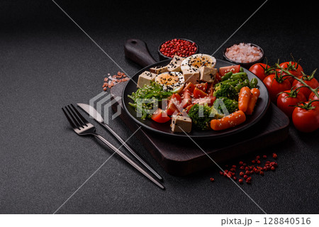 Vegan salad, bowls with chickpeas, broccoli, tomatoes, tofu cheese and boiled eggs 128840516