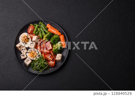 Vegan salad, bowls with chickpeas, broccoli, tomatoes, tofu cheese and boiled eggs Vegan salad, bowls with chickpeas, broccoli, tomatoes, tofu cheese and boiled eggs 128840529