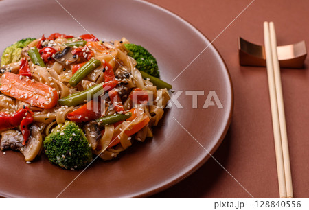 Chinese or Thai food, rice noodles with meat, salt and spices. Asian food Chinese or Thai food, rice noodles with meat, salt and spices. Asian food 128840556
